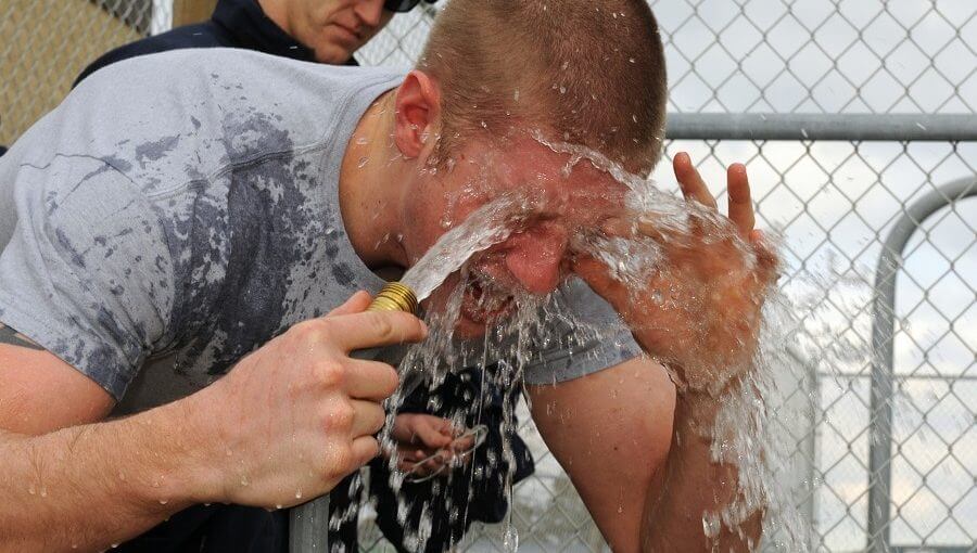 Pepper spray victim rinsing his eyes