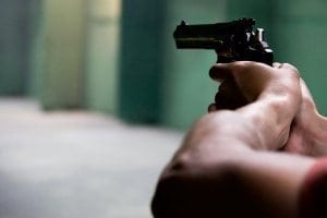 Closeup of man aiming a gun