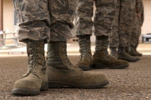 People in camo pants wearing combat boots