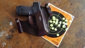 Weapon in holster with target behind it