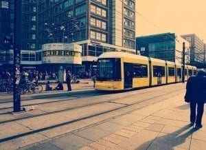 Train outside in front of buildings