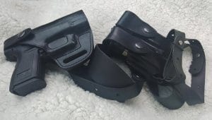 Black holsters on white carpet