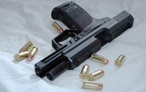 Black firearm surrounded by bullets